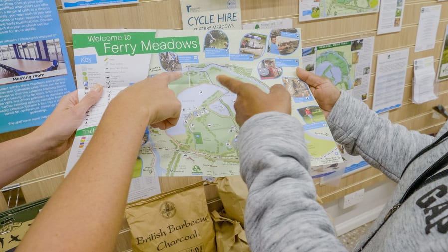 a map of ferry meadows being held and pointed at