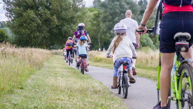 family cycling through a country park