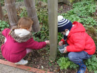 two young children enjoying outdoor learning