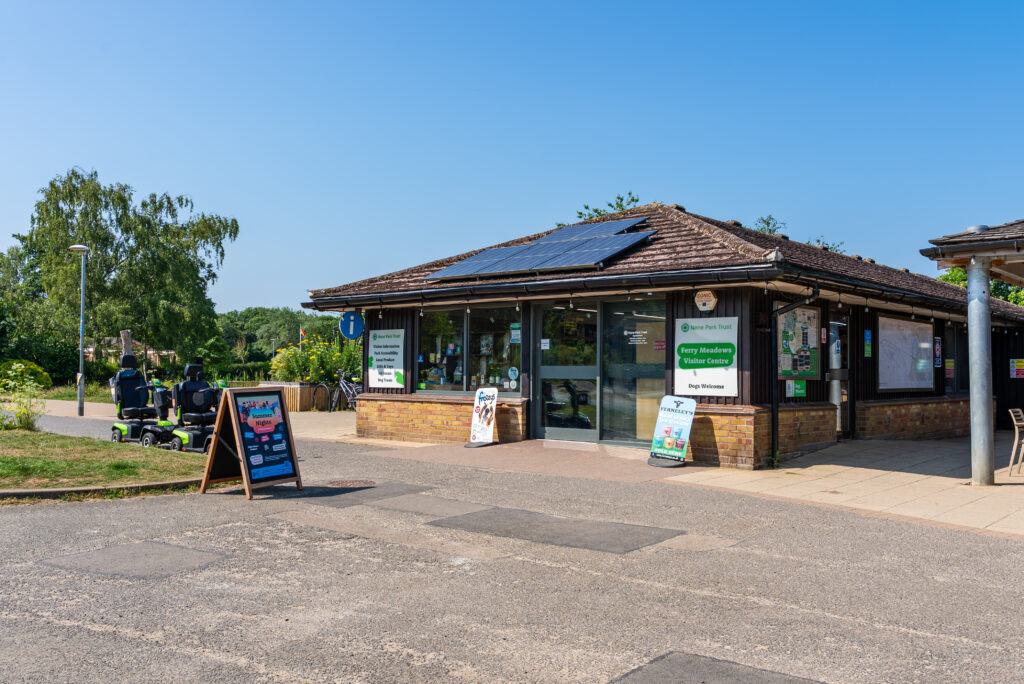 Single story brown brick Visitor Centre building with signage around the outside