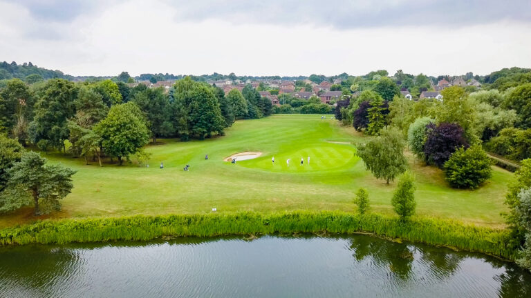 Golf Course with lake in the foreground. Orton Meadows Golf Course