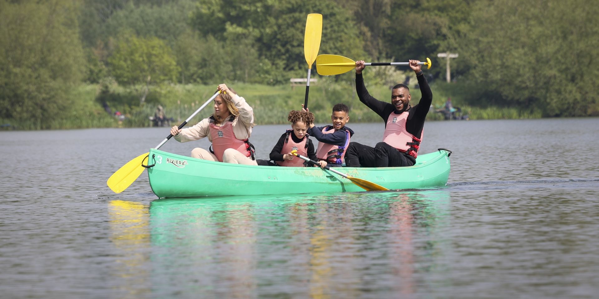 Family of four enjoying a canoe activity in a lake