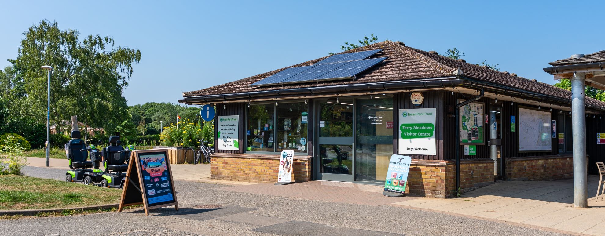 The outside of the Ferry Meadows visitor centre, a one story brick building with colourful signage outside