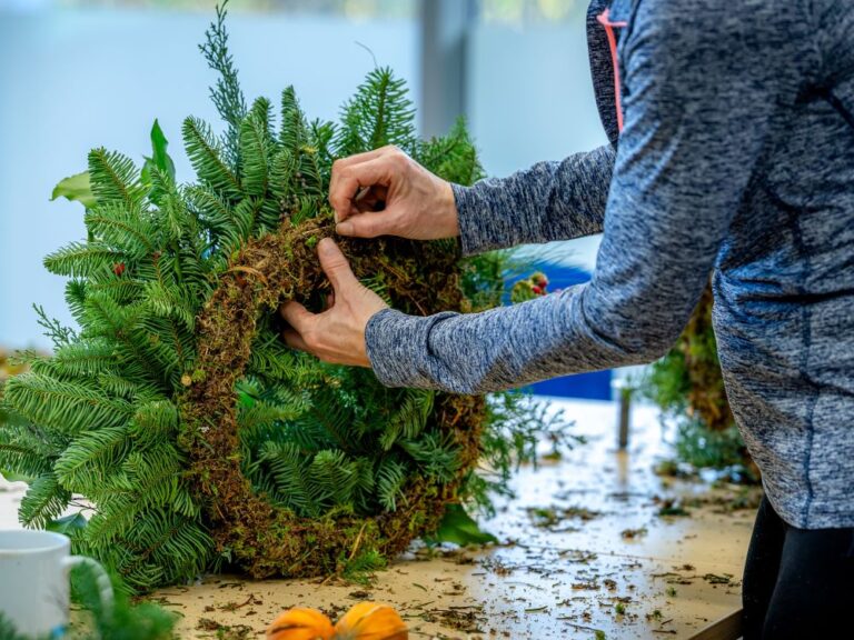 woman making a Christmas wreath in a craft workshop