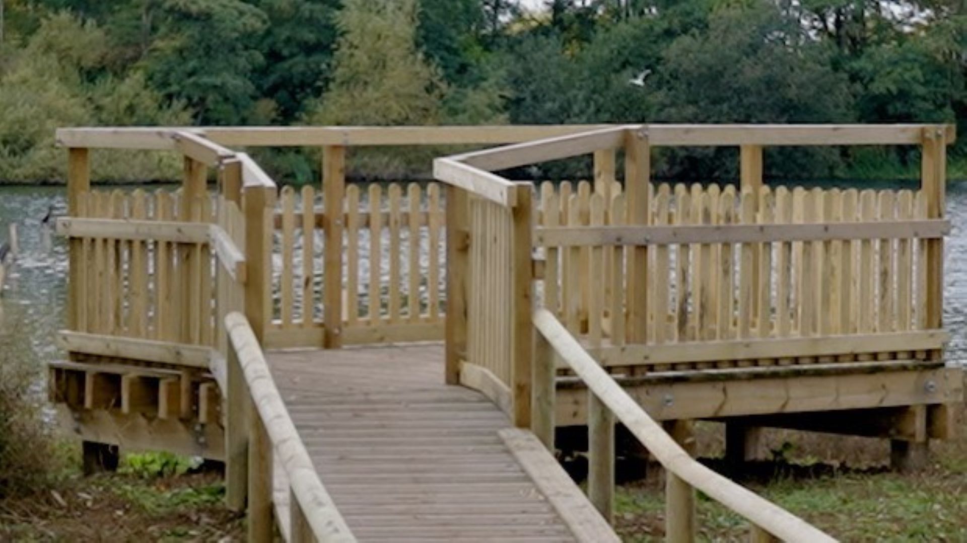 Wooden viewing platform looking out onto a lake