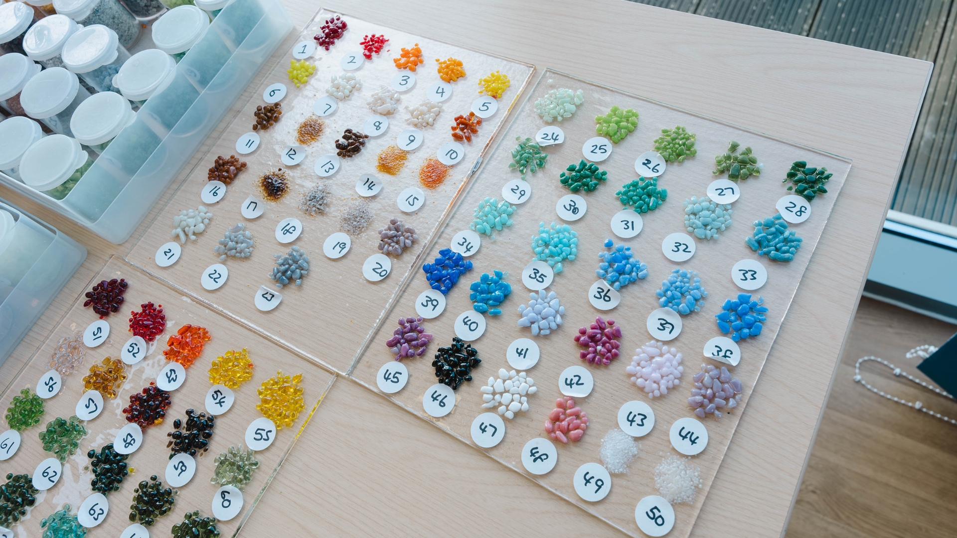 A varied selection of different coloured glass and marble decorations used in fused glass workshops. Each sample comes in a different size, colour and texture although most are smaller than fine gravel.