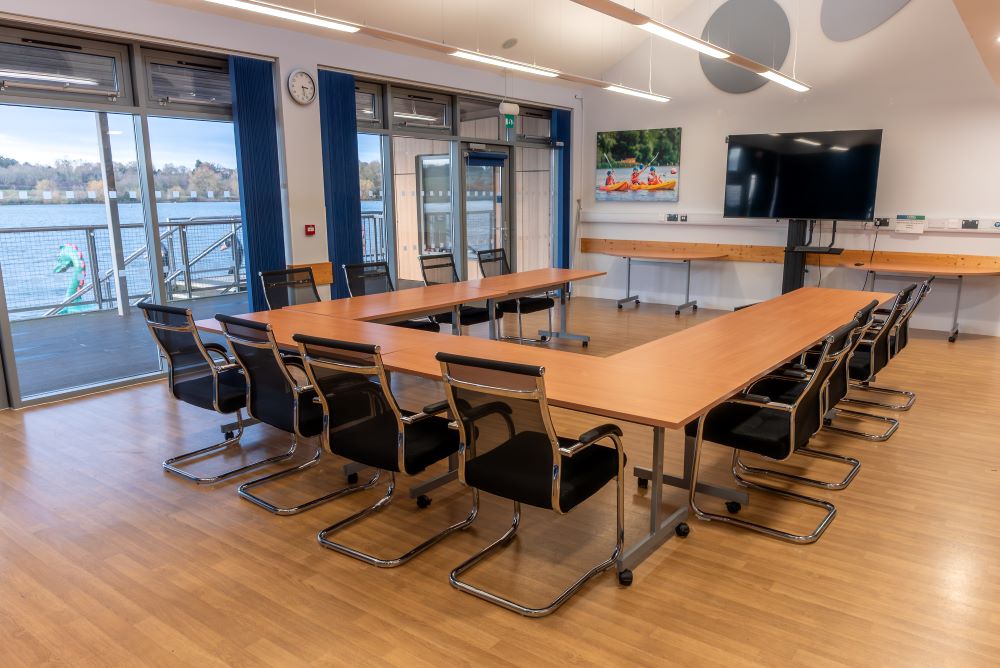 lakeside meeting room set up with a horseshoe table and chairs layout