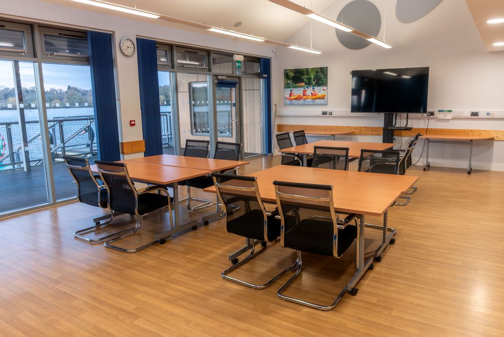lakeside meeting room set up with tables and chairs