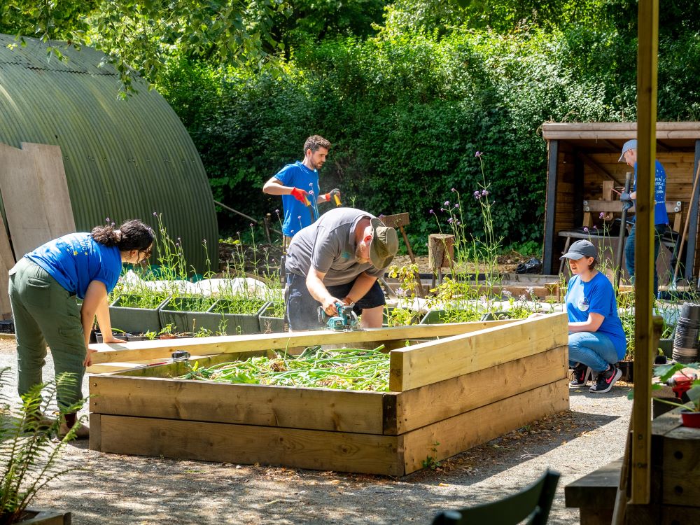 a group of volunteers building a flower bed