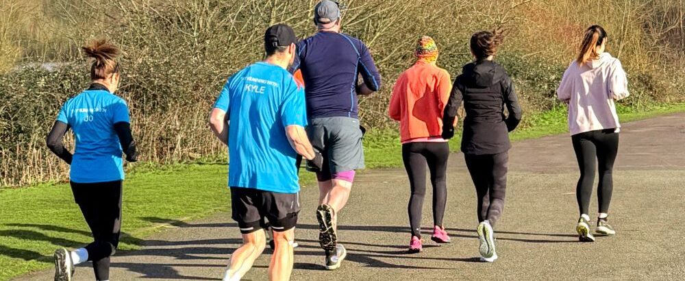 Group of runners on an accessible path through a country park