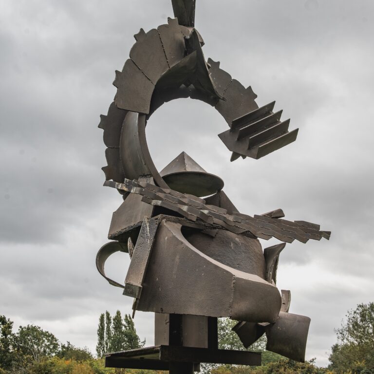 Steel sculpture in a landscape setting.