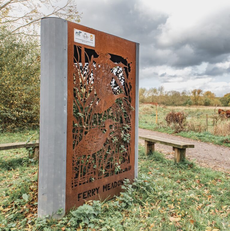 Steel sculpture in a landscape setting.