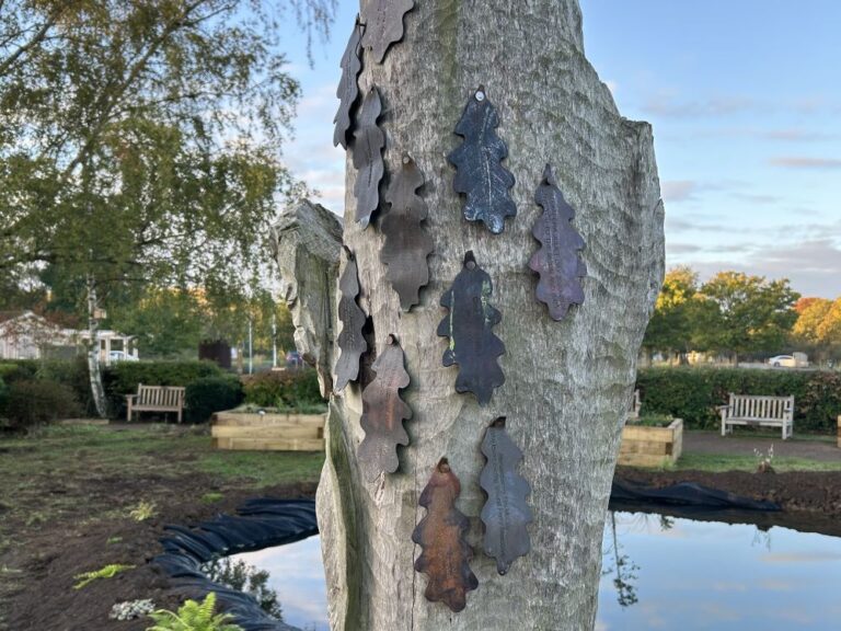 Bronze celebration leaves displayed on an oak sculpture