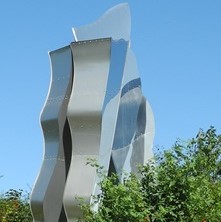 Metal sculpture with trees below