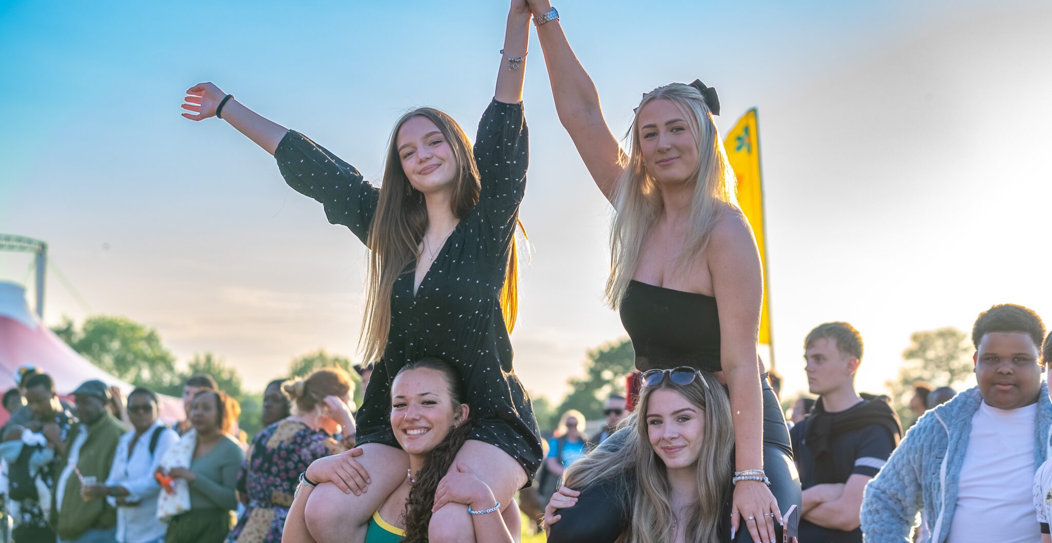 Young girls enjoying an outdoor music festival