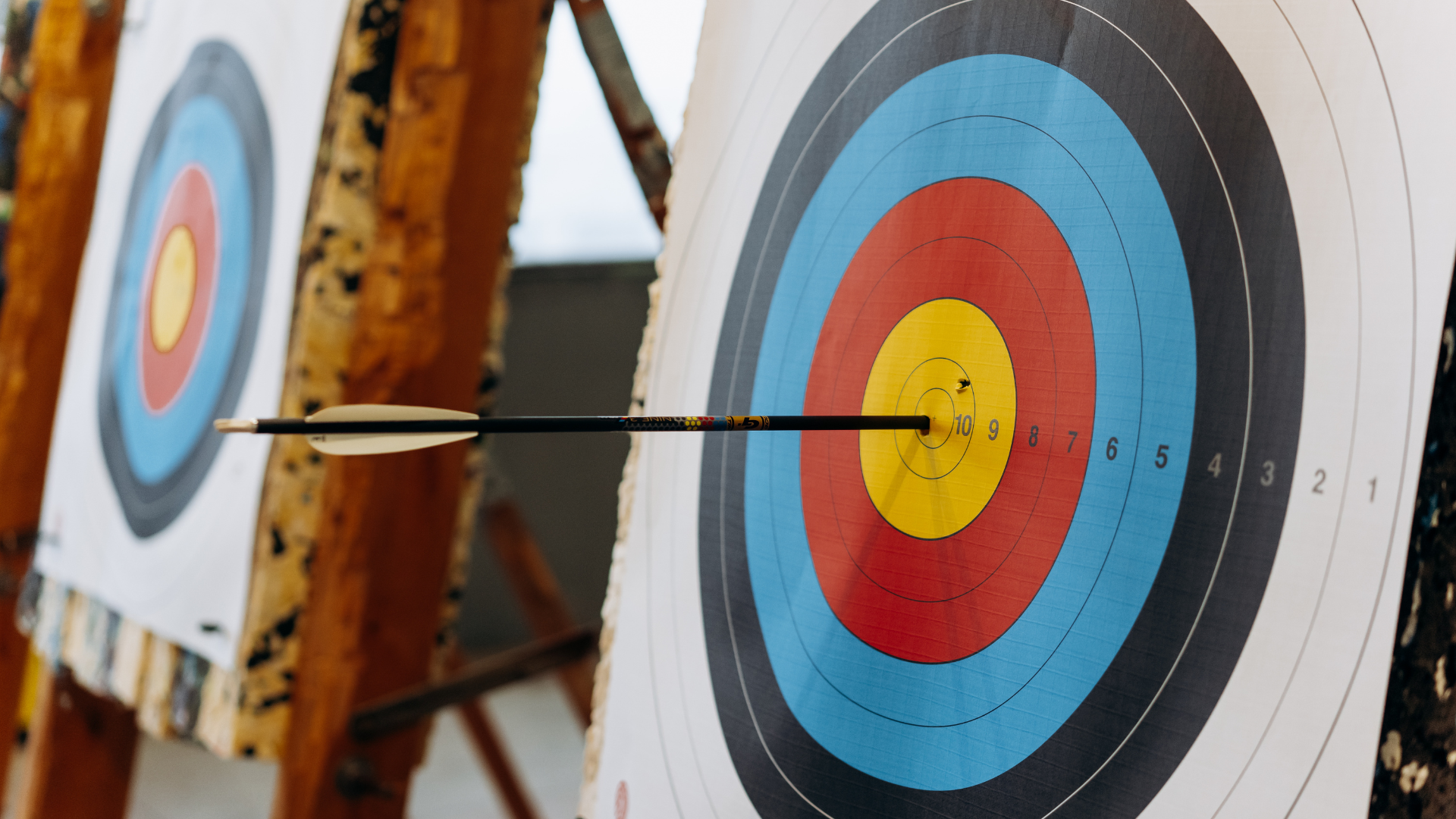 Two archery targets with an arrow in the bullseye