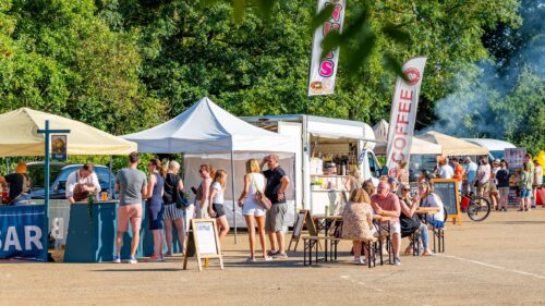 An outdoor festival with different food and drink vendors