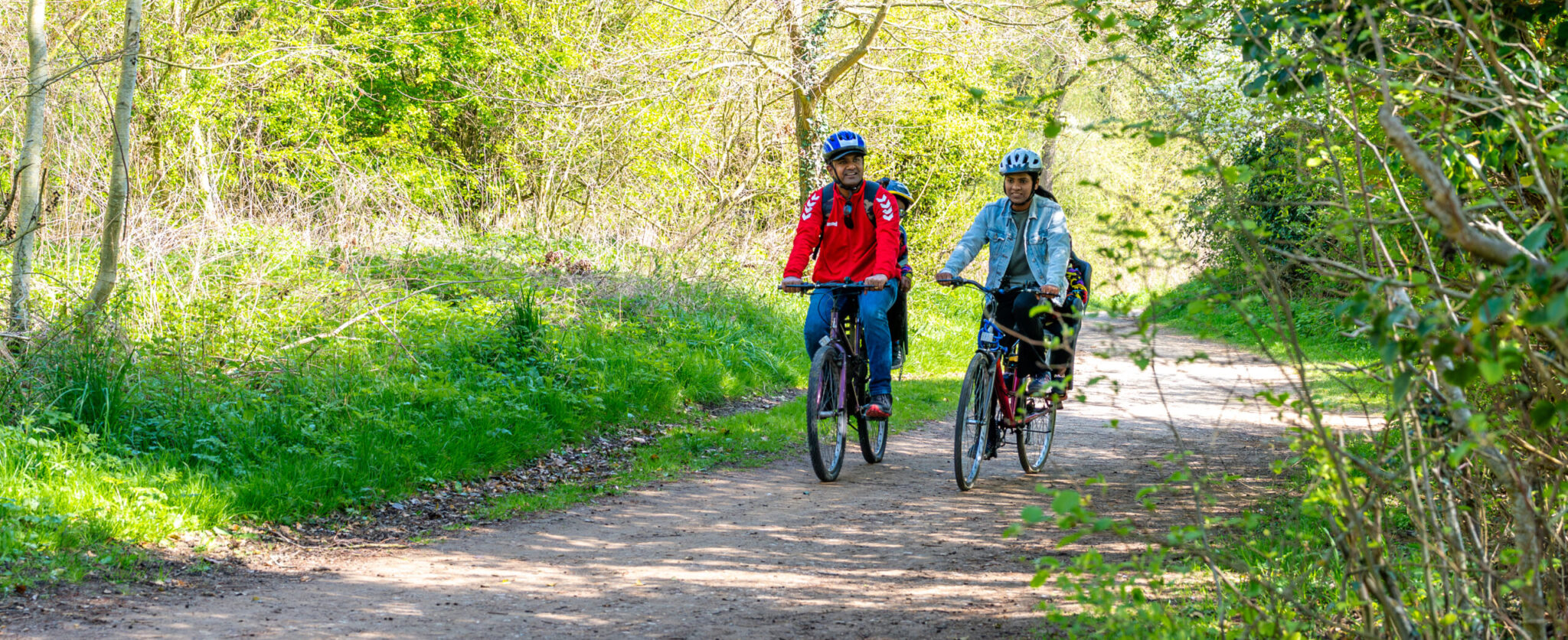Couple cycling in the woods.