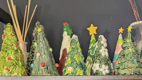handmade pottery christmas trees on a shelf