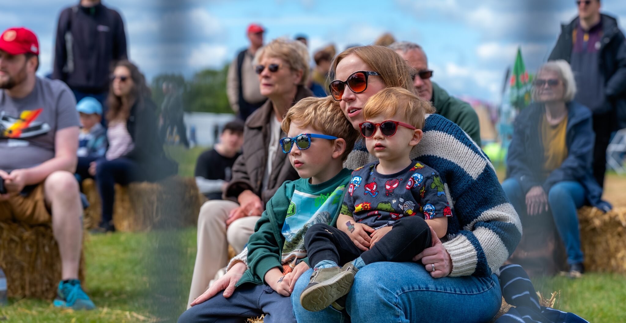 Family at an outdoors festival enjoying the entertainment